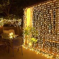 JMEXSUSS 300 LED Remote Control Christmas Curtain Lights, Plug in Fairy Curtain Lights Outdoor, Window Wall Hanging String Lights for Bedroom Backdrop Wedding Party Indoor Patio Xmas Decor, Warm White