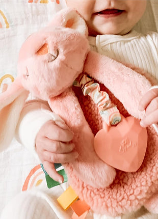 Itzy Ritzy - Itzy Lovey Including Teether - Baby Lovey with Teether, Textured Ribbons & Dangle Arms - Features Crinkle Sound, Sherpa Fabric and Minky Plush (Pink Bunny)