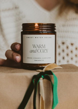 Sweet Water Decor Warm & Cozy Candle, 9oz Amber Glass Jar, Winter Scents | Cozy Scented Candle with Orange Peel, Cinnamon, Ginger & Clove Notes, Black Lid, 40+ Hour Burn Time, Poured in the USA