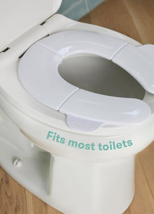 Frida Baby Fold-and-Go Portable Potty Seat for Toilet, Foldable Travel Potty Seat for Toddler, Fits Round & Oval Toilets, Non-Slip Base, Handles, Includes Free Travel Bag