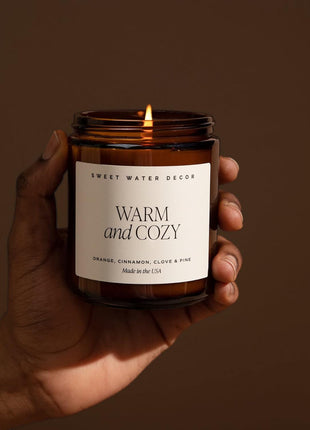 Sweet Water Decor Warm & Cozy Candle, 9oz Amber Glass Jar, Winter Scents | Cozy Scented Candle with Orange Peel, Cinnamon, Ginger & Clove Notes, Black Lid, 40+ Hour Burn Time, Poured in the USA